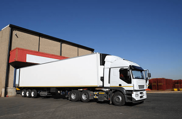 refrigerated semi truck at a cold storage warehouse loading bay